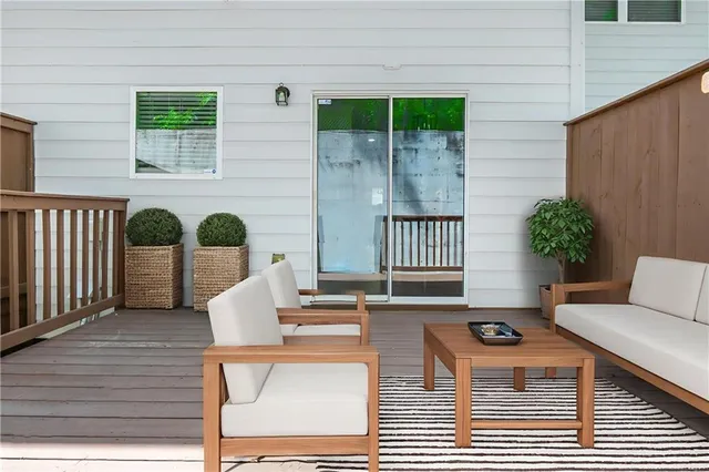 a balcony with furniture and a potted plant