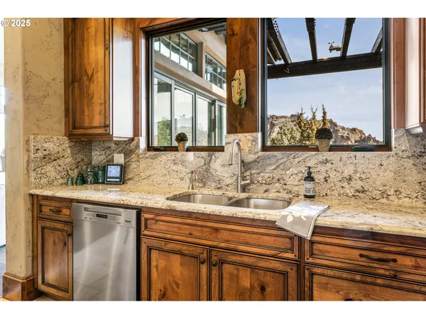 a kitchen with a granite countertop sink and a stove