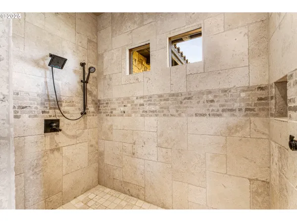 a bedroom with a bed and a large window