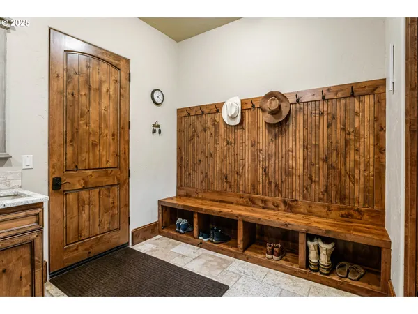 a spacious bathroom with a granite countertop sink and a washing machine