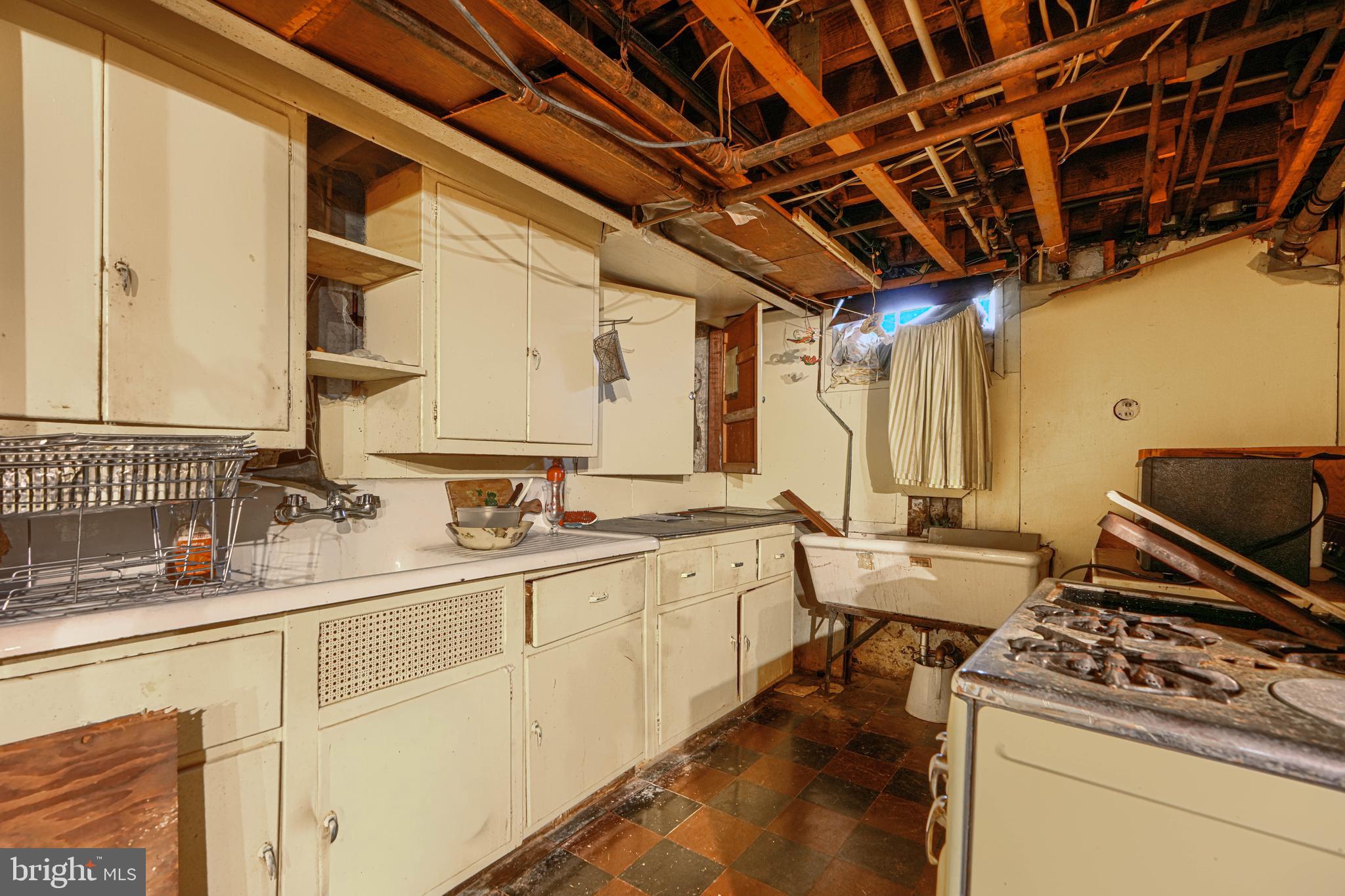 3212 Dorchester Road Baltimore, MD 21215 - Photo 45 of 45 a kitchen with a sink stove and cabinets