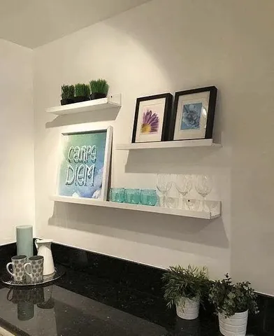 a front view of a house with a book shelf