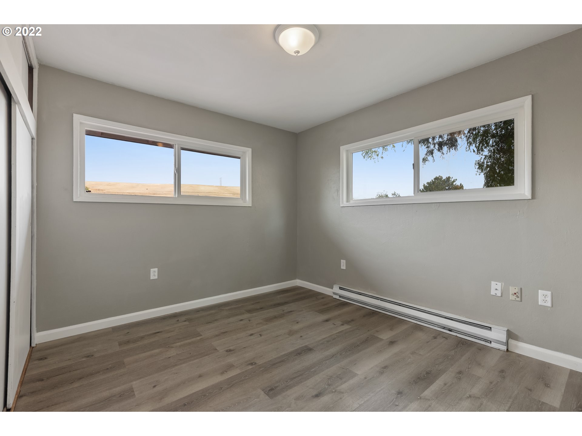 46145 Adams Road Pendleton, OR 97801 - Photo 7 of 12 a view of an empty room with wooden floor and a window
