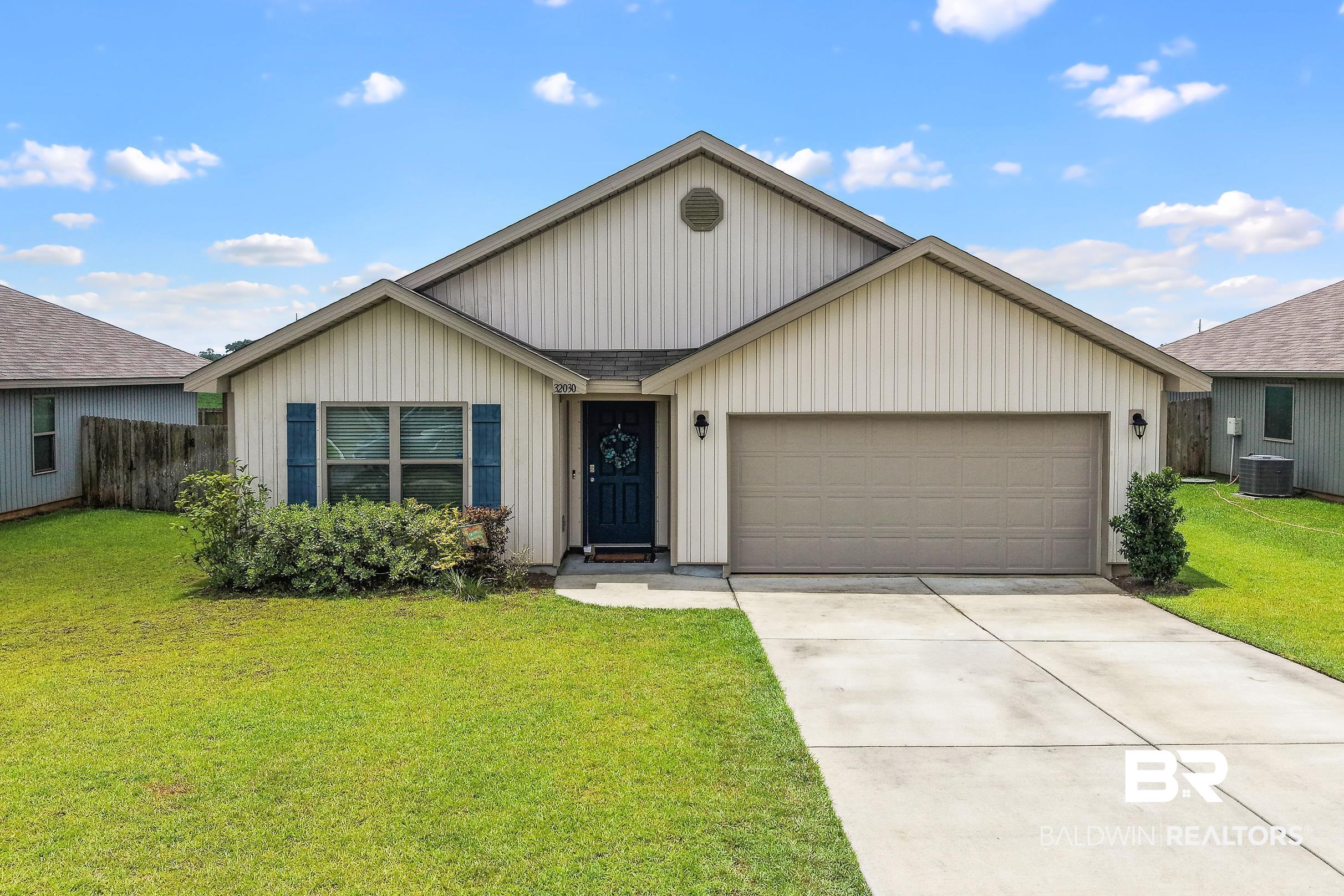 32030 Terranova Loop Lillian, AL 36549 - Photo 1 of 30 Traditional-style residence featuring a prominent front-facing gable, beige vertical siding, and a two-car garage