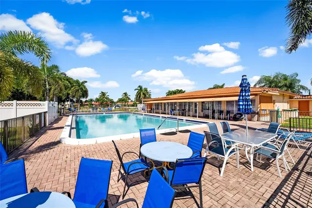 a balcony with table and chairs