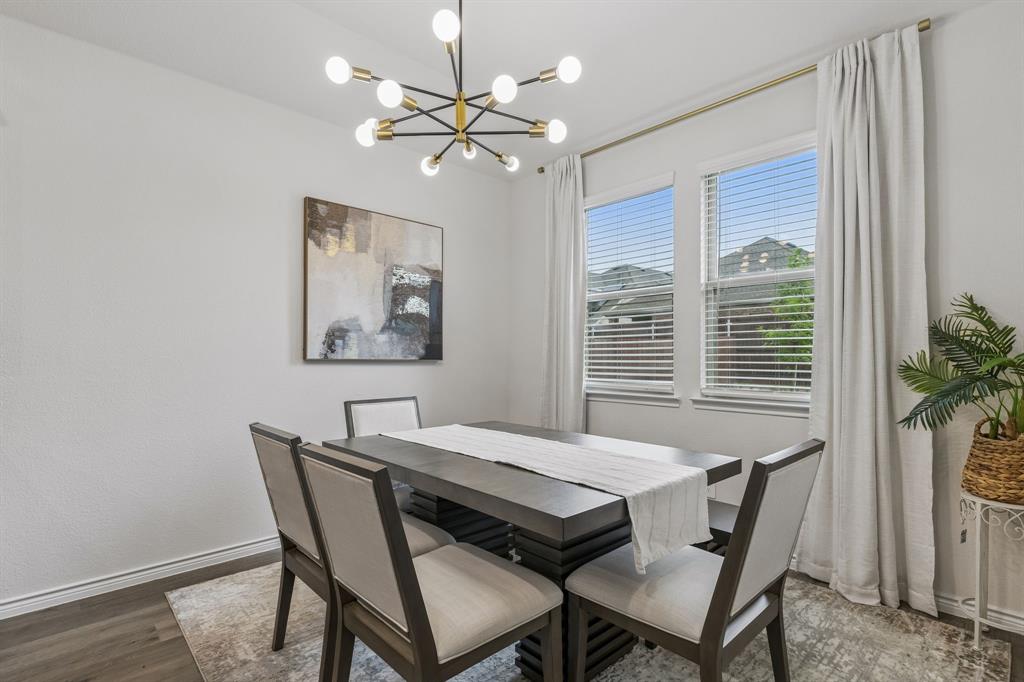 10313 Geode Street Aubrey, TX 76227 - Photo 9 of 13 Dining area featuring a modern sputnik chandelier and wood-finish flooring