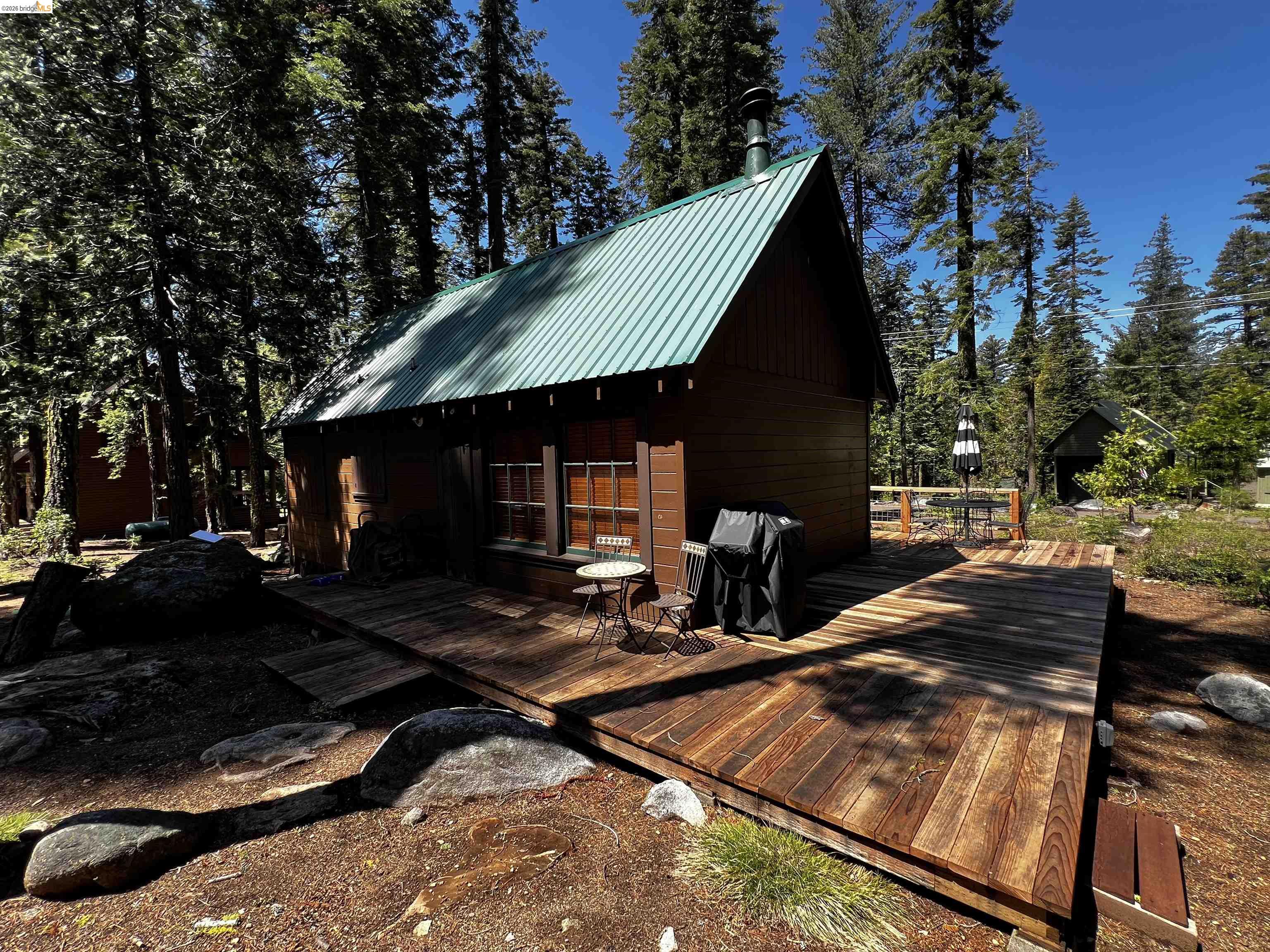 39 Cow Creek Road Pinecrest, CA 95364 - Photo 11 of 44 a view of a house with backyard and sitting area