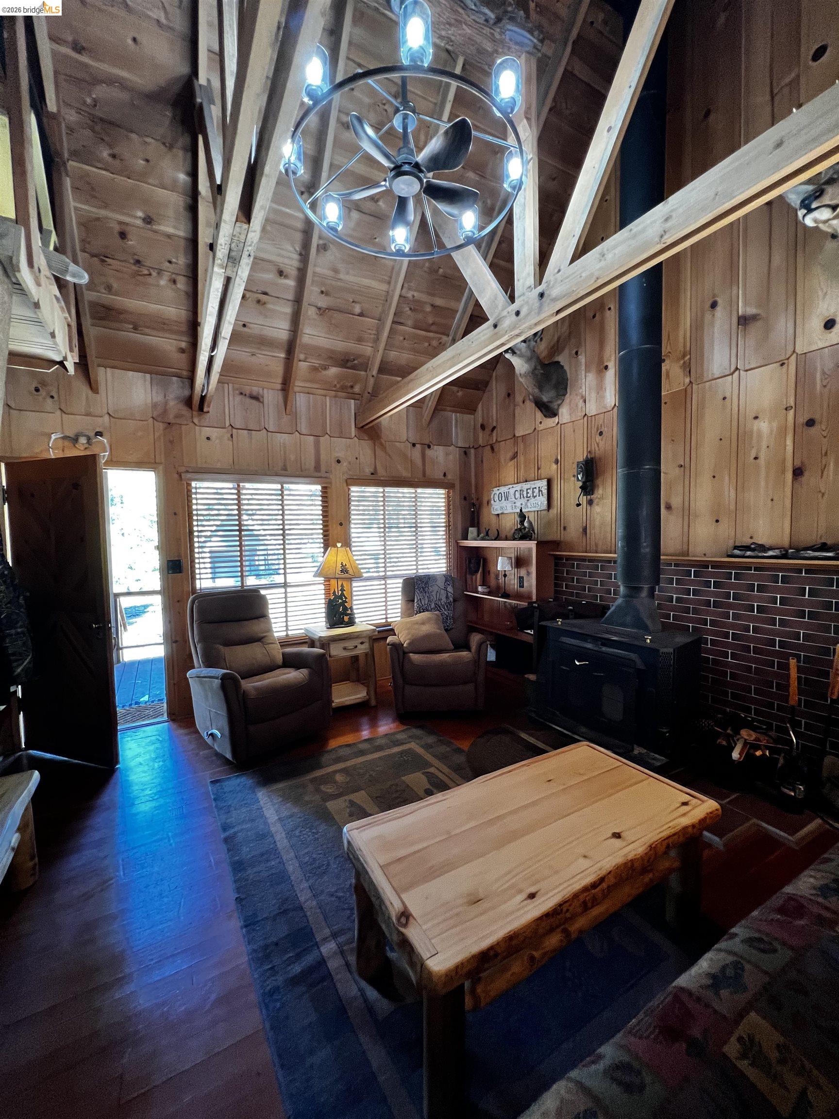 39 Cow Creek Road Pinecrest, CA 95364 - Photo 21 of 44 a living room with lots of furniture and a chandelier