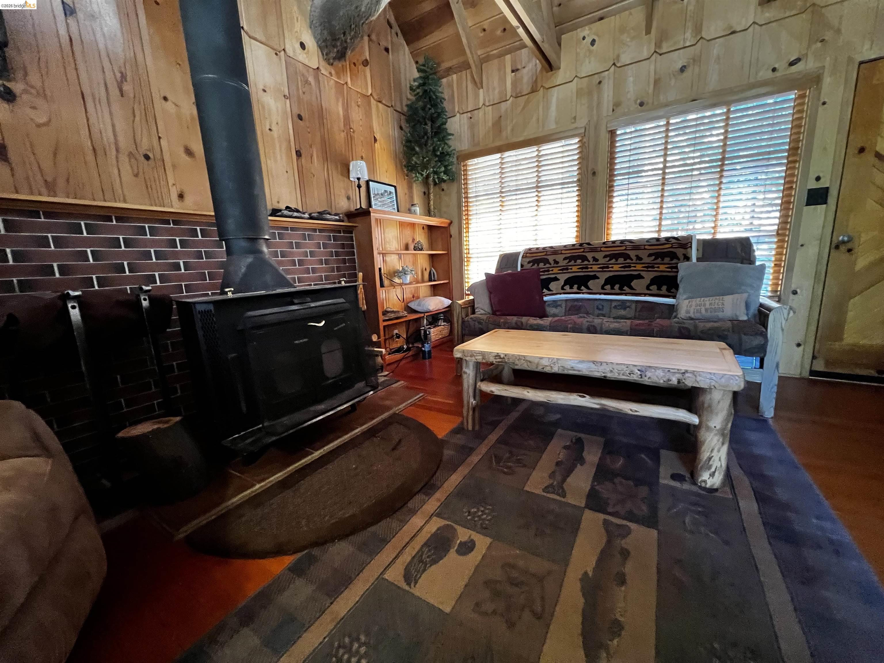 39 Cow Creek Road Pinecrest, CA 95364 - Photo 24 of 44 a living room with furniture fireplace and wooden floor