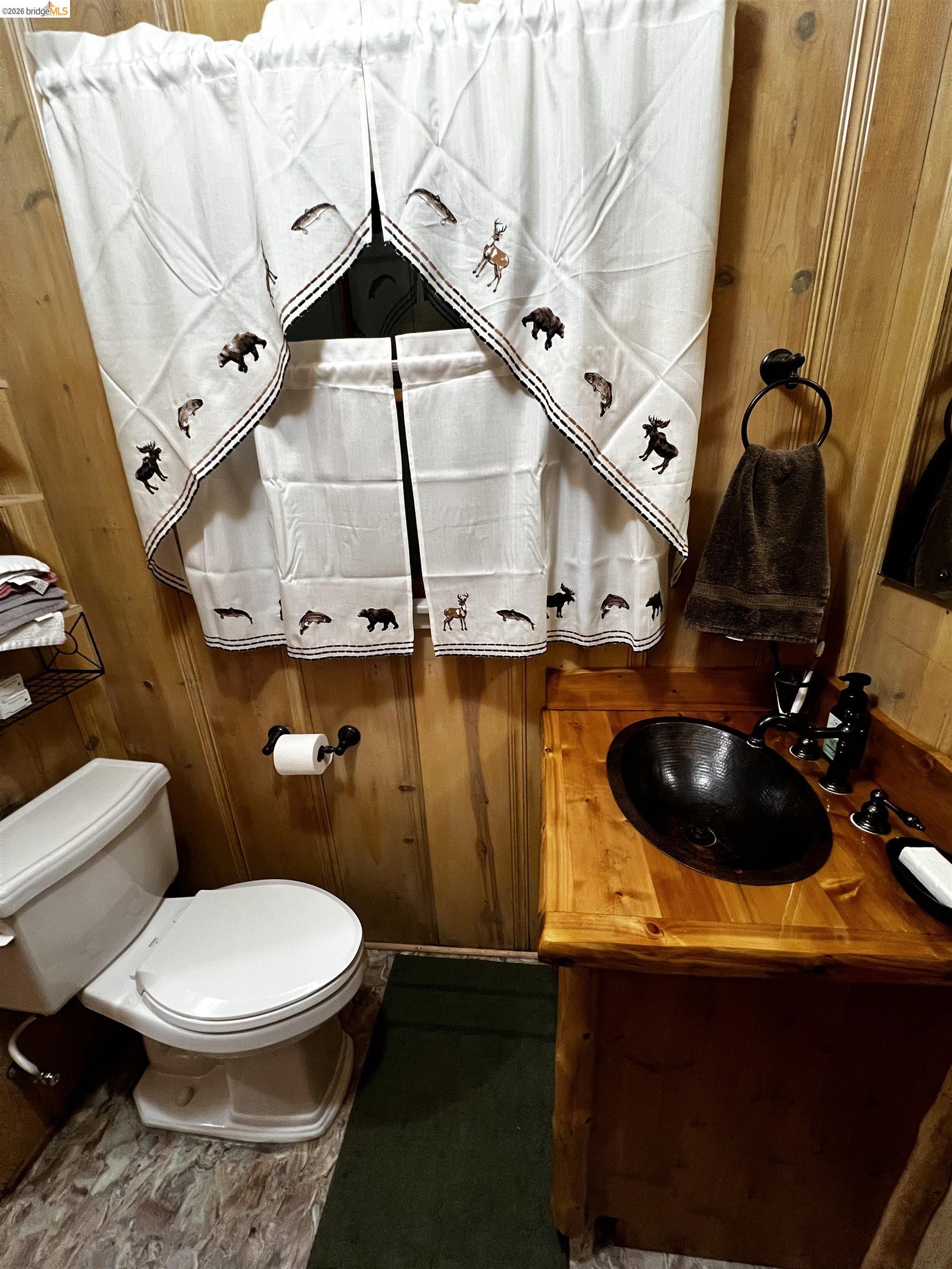 39 Cow Creek Road Pinecrest, CA 95364 - Photo 29 of 44 a bathroom with a toilet sink and mirror