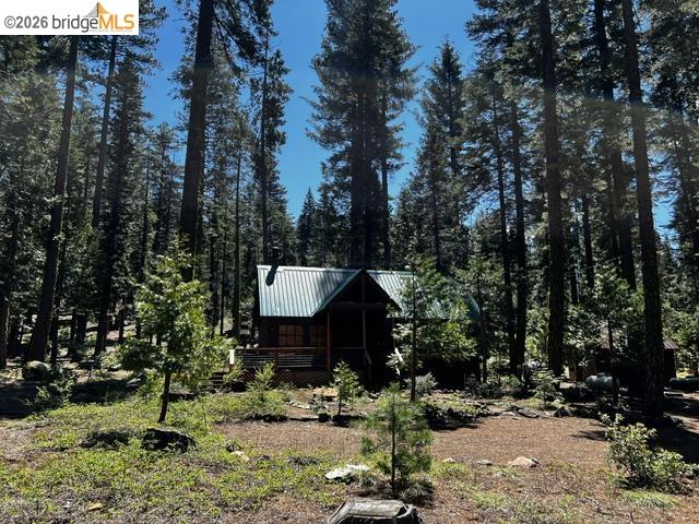 39 Cow Creek Road Pinecrest, CA 95364 - Photo 8 of 44 a backyard of a house with table and chairs