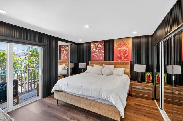 a bedroom with a large bed and a large window