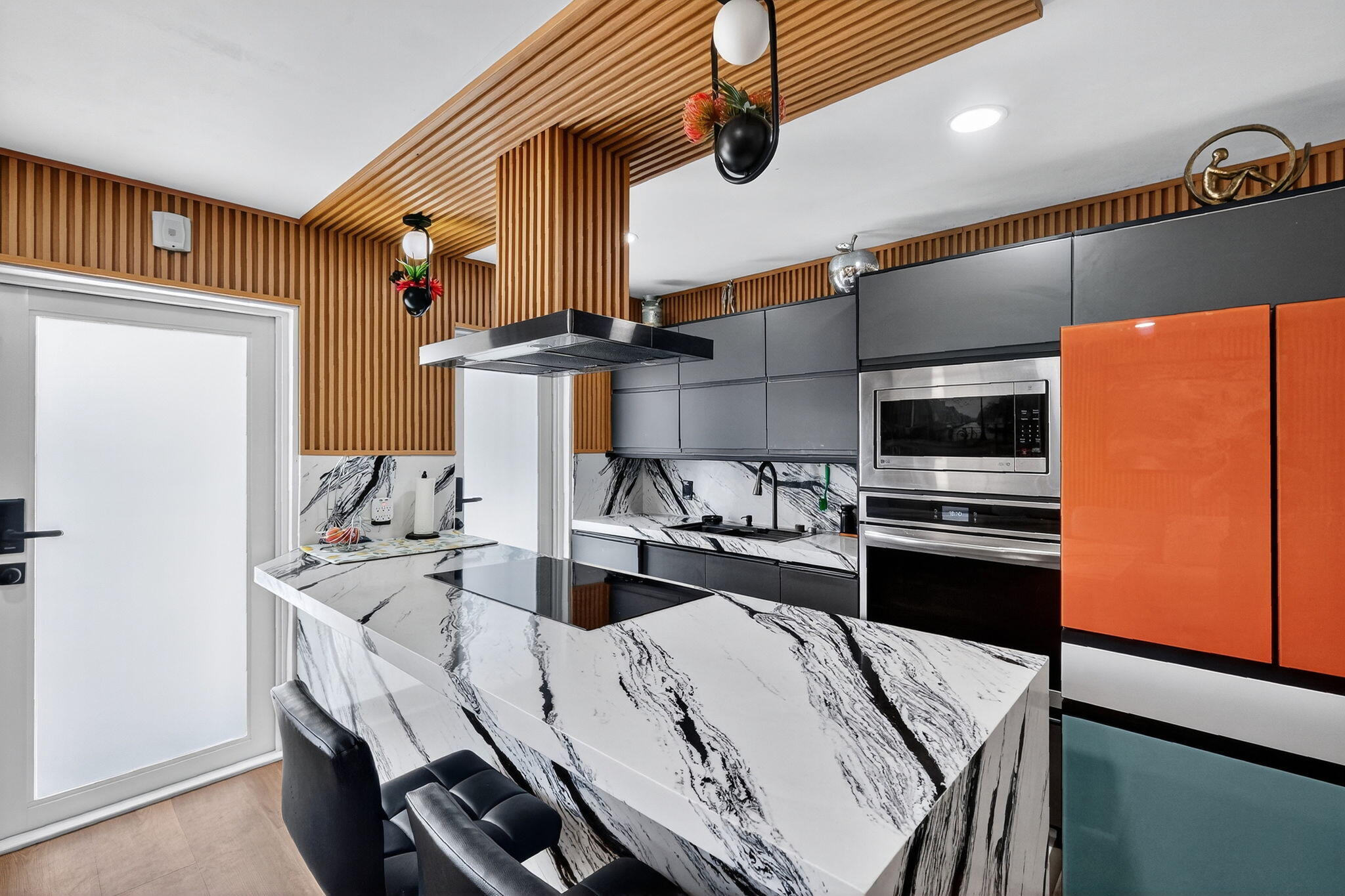 363 Washington Avenue, Unit 32 Miami Beach, FL 33139 - Photo 8 of 32 a kitchen with stainless steel appliances kitchen island a stove a table and chairs