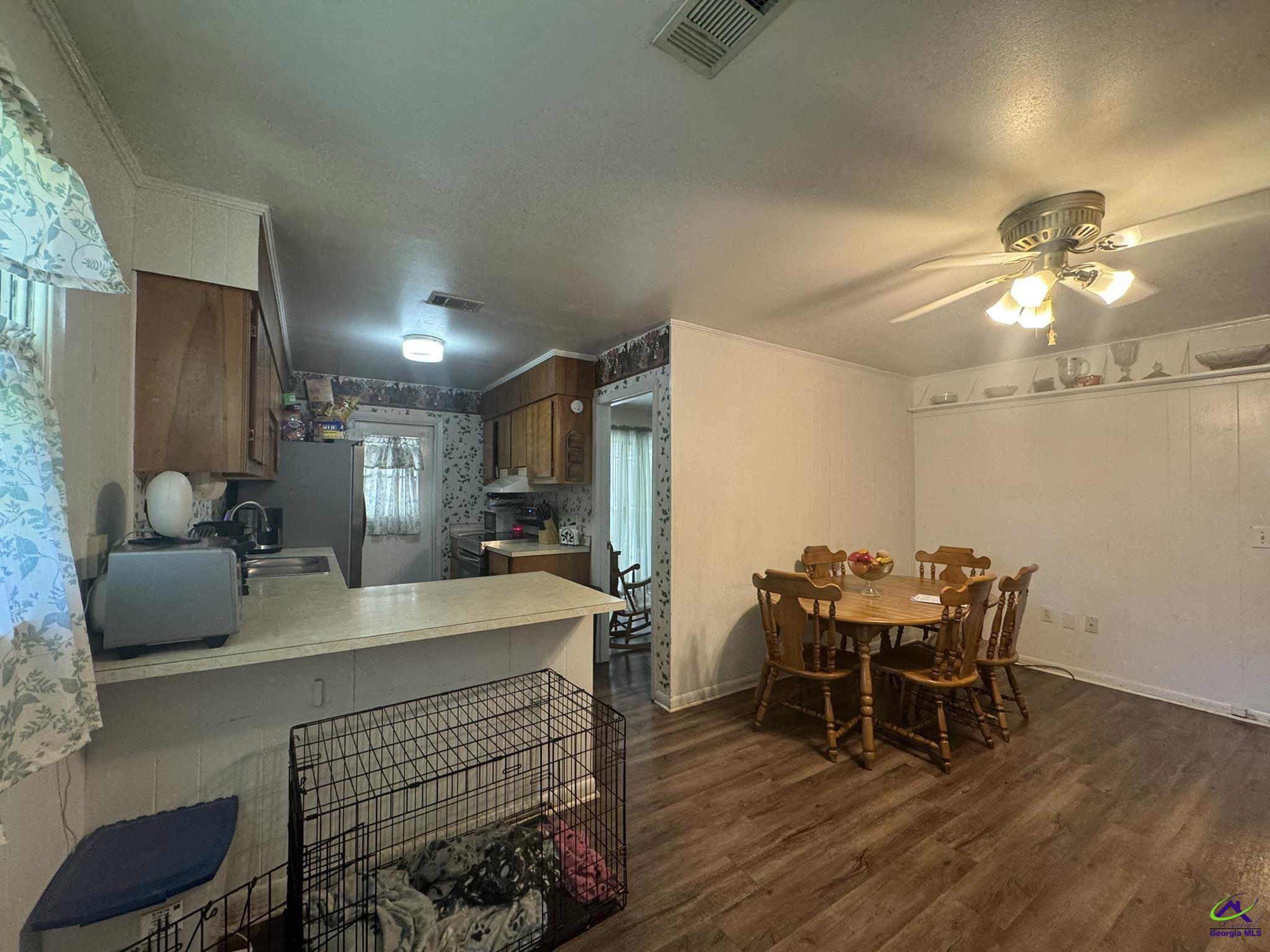 1032 Elberta Road Warner Robins, GA 31093 - Photo 7 of 26 a view of a dining room with furniture and wooden floor