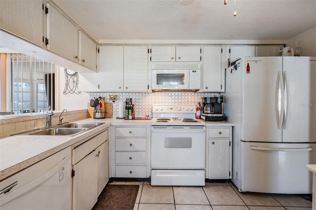 3608 Umber Road Holiday, FL 34691 - Photo 6 of 20 a kitchen with a white cabinets and white appliances