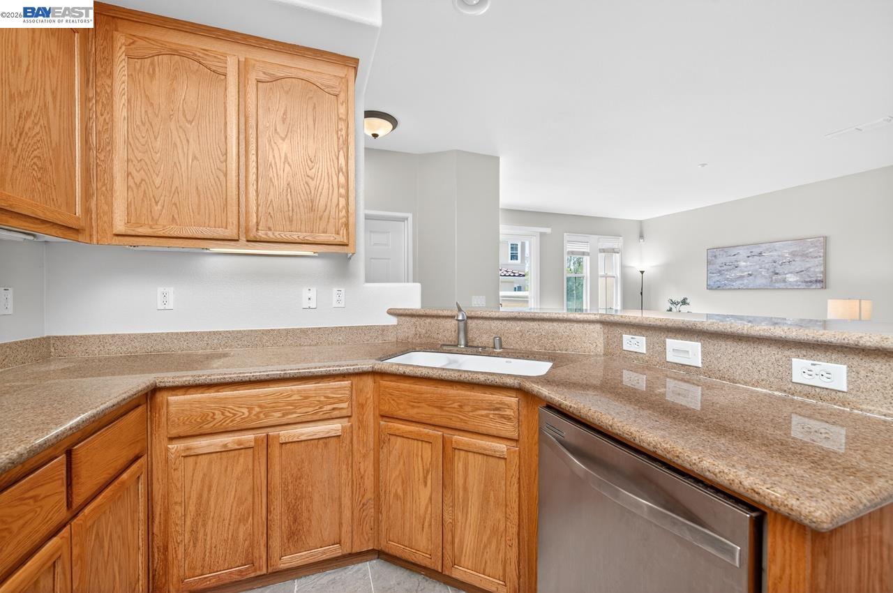 3391 Monaghan Street Dublin, CA 94568 - Photo 9 of 57 a kitchen with stainless steel appliances granite countertop a sink and cabinets