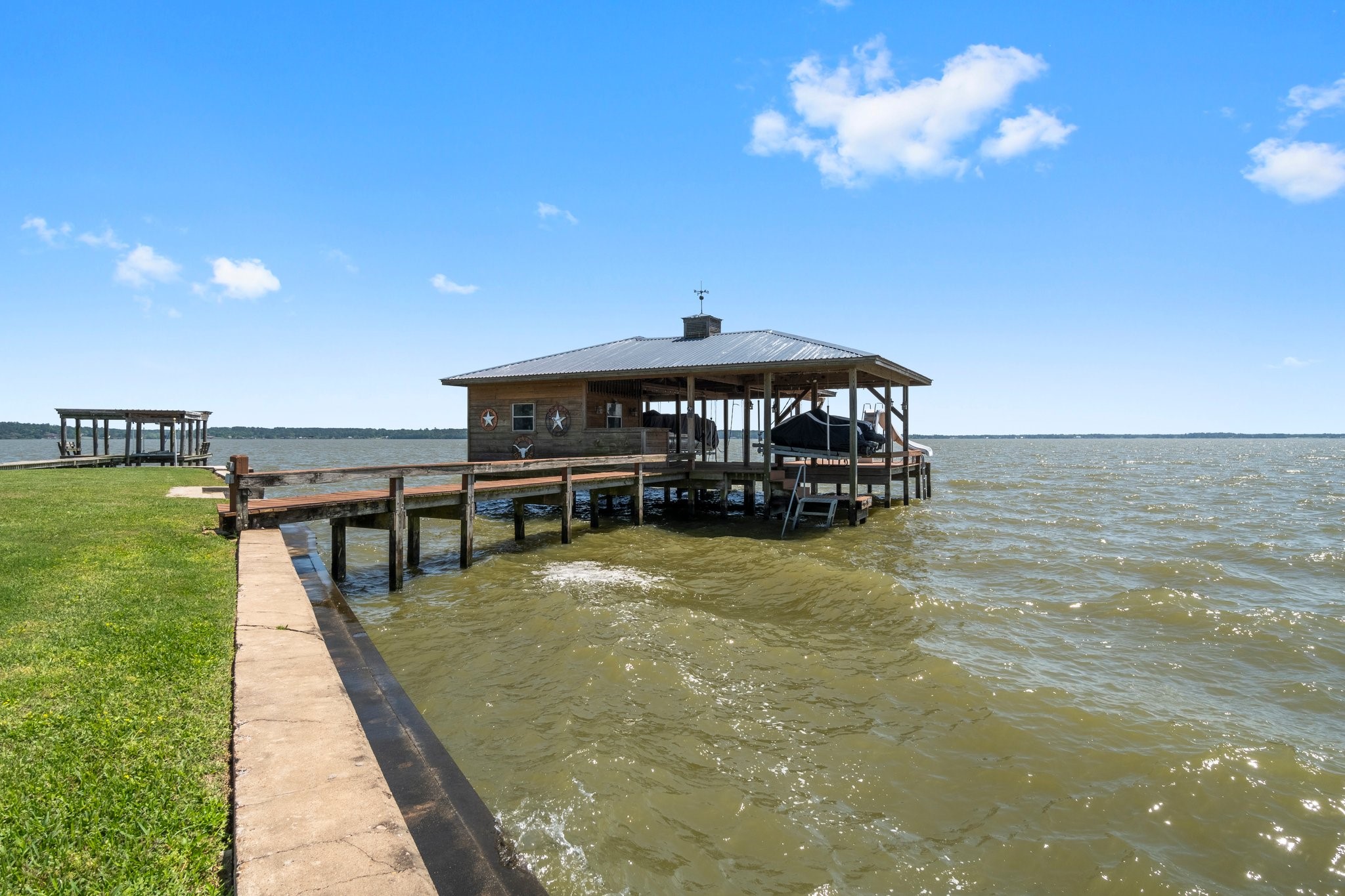 237 Vivian Road Onalaska, TX 77360 - Photo 45 of 49 A durable concrete bulkhead, pier and boat house of fun on the water