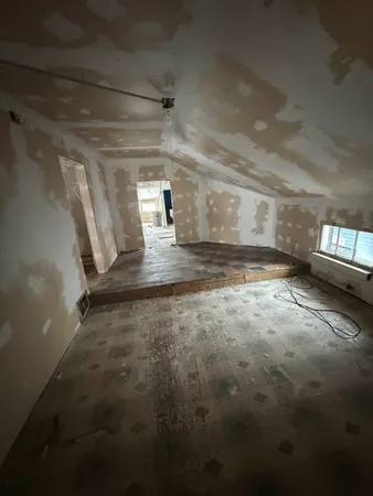 a view of a livingroom with chairs and a fireplace