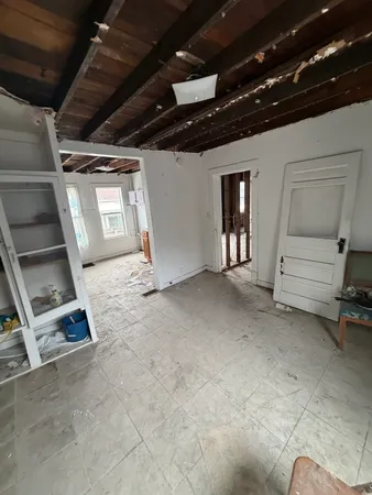 a view of an empty room with stairs and ventilation