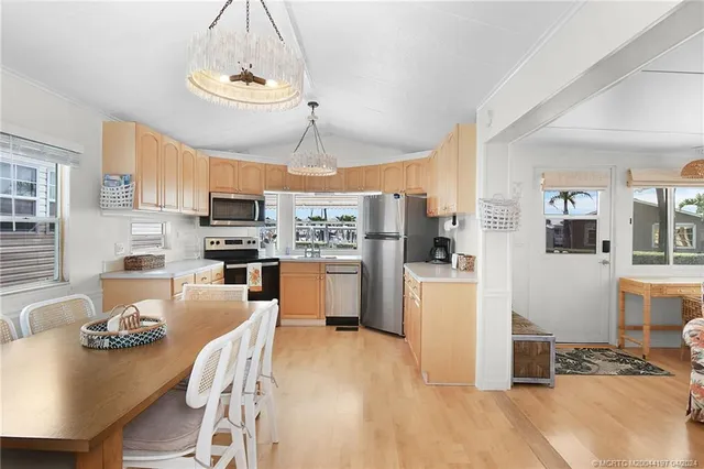 a kitchen with stainless steel appliances granite countertop a refrigerator stove a sink and a microwave