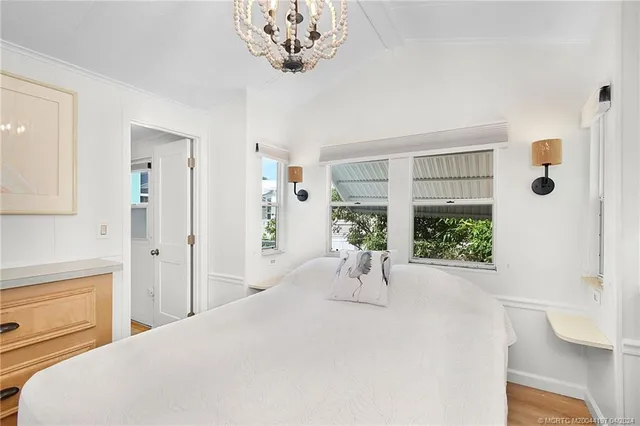 a bedroom with a bed and a chandelier