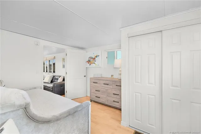 a bedroom with a bed and a dresser in it