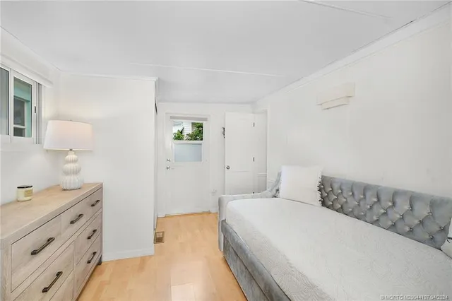 a view of a balcony with wooden floor and fence