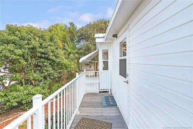 a view of a balcony with wooden floor and fence