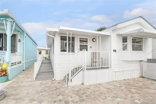 a view of a house with a sink and wooden floor