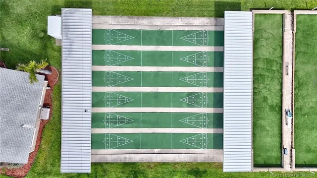 an aerial view of a house with yard swimming pool and outdoor seating