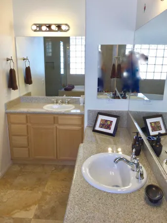 a bathroom with a sink double vanity and a mirror