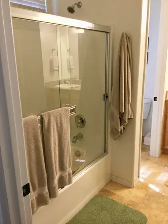 a bathroom with a shower and a tub