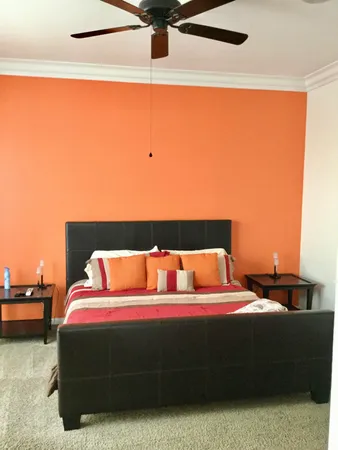 a bedroom with a bed and a night stand
