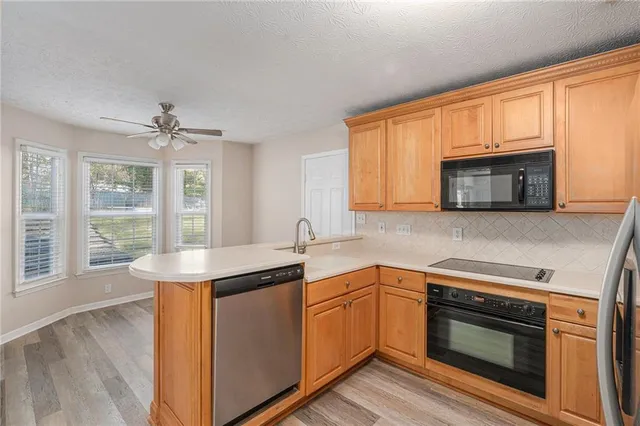 a kitchen with stainless steel appliances a stove sink and microwave
