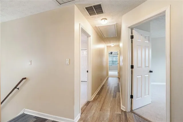 a view of a hallway with wooden floor