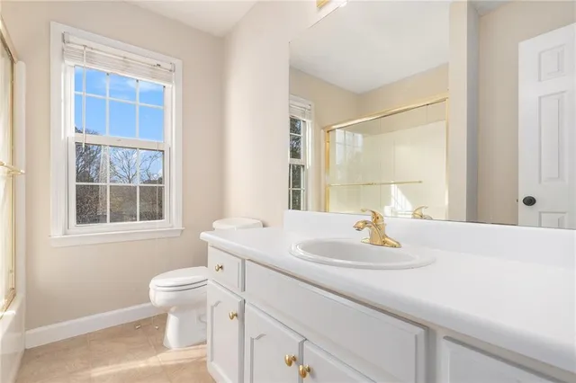 a bathroom with a sink toilet and a mirror