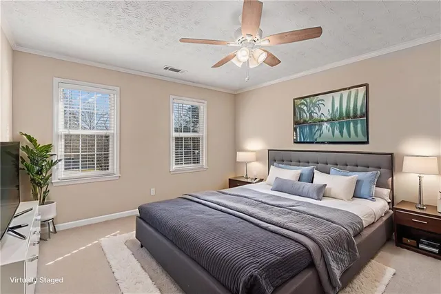 a bedroom with a large bed and a window