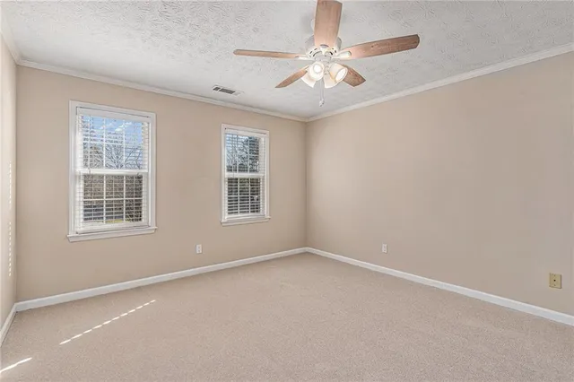 an empty room with chandelier fan