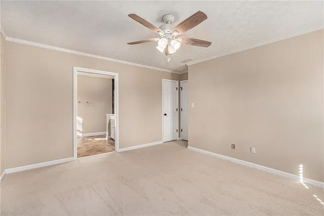 an empty room with fan and a ceiling fan