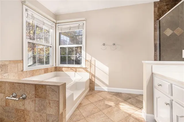 a spacious bathroom with a bathtub and next to a window