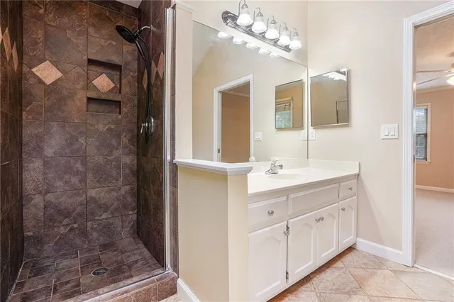 a bathroom with a double vanity sink mirror and shower