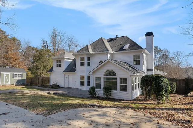a view of a white house with a yard