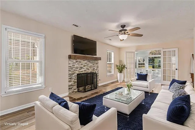 a living room with furniture a fireplace and a flat screen tv