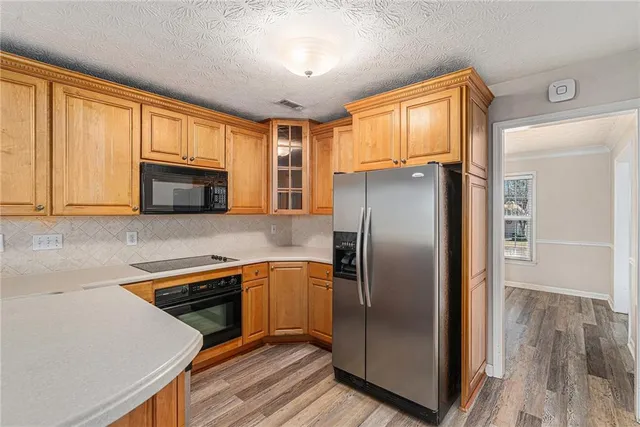 a kitchen with stainless steel appliances a refrigerator sink and microwave