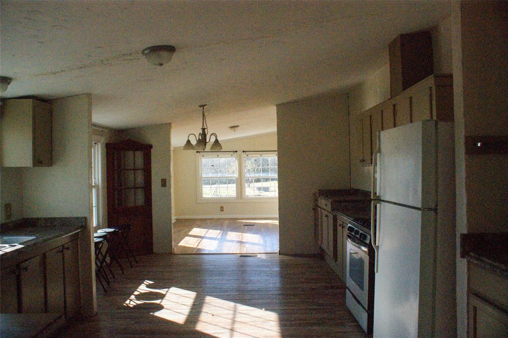 7424 North Locust Street Denton, TX 76207 - Photo 8 of 9 a kitchen with stainless steel appliances wooden floor and a refrigerator