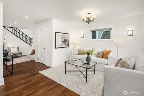 a living room with furniture and a chandelier
