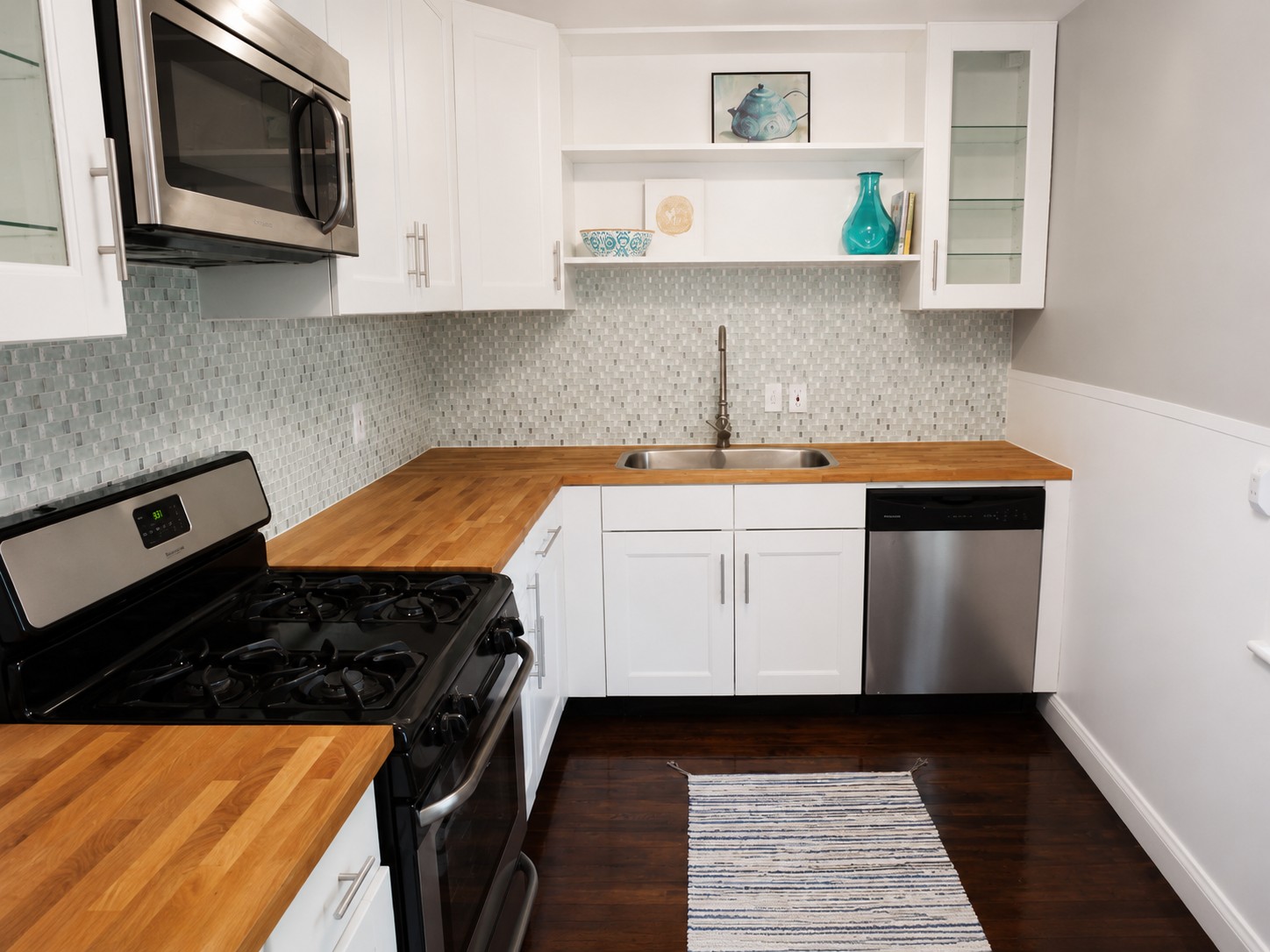 907 East 56th Street Austin, TX 78751 - Photo 8 of 13 a kitchen with a stove and a microwave