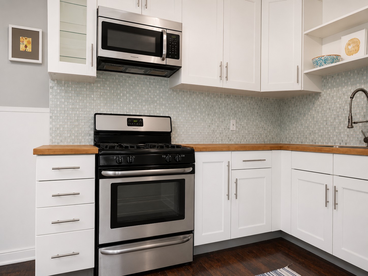 907 East 56th Street Austin, TX 78751 - Photo 9 of 13 a kitchen with cabinets stainless steel appliances and wooden floor