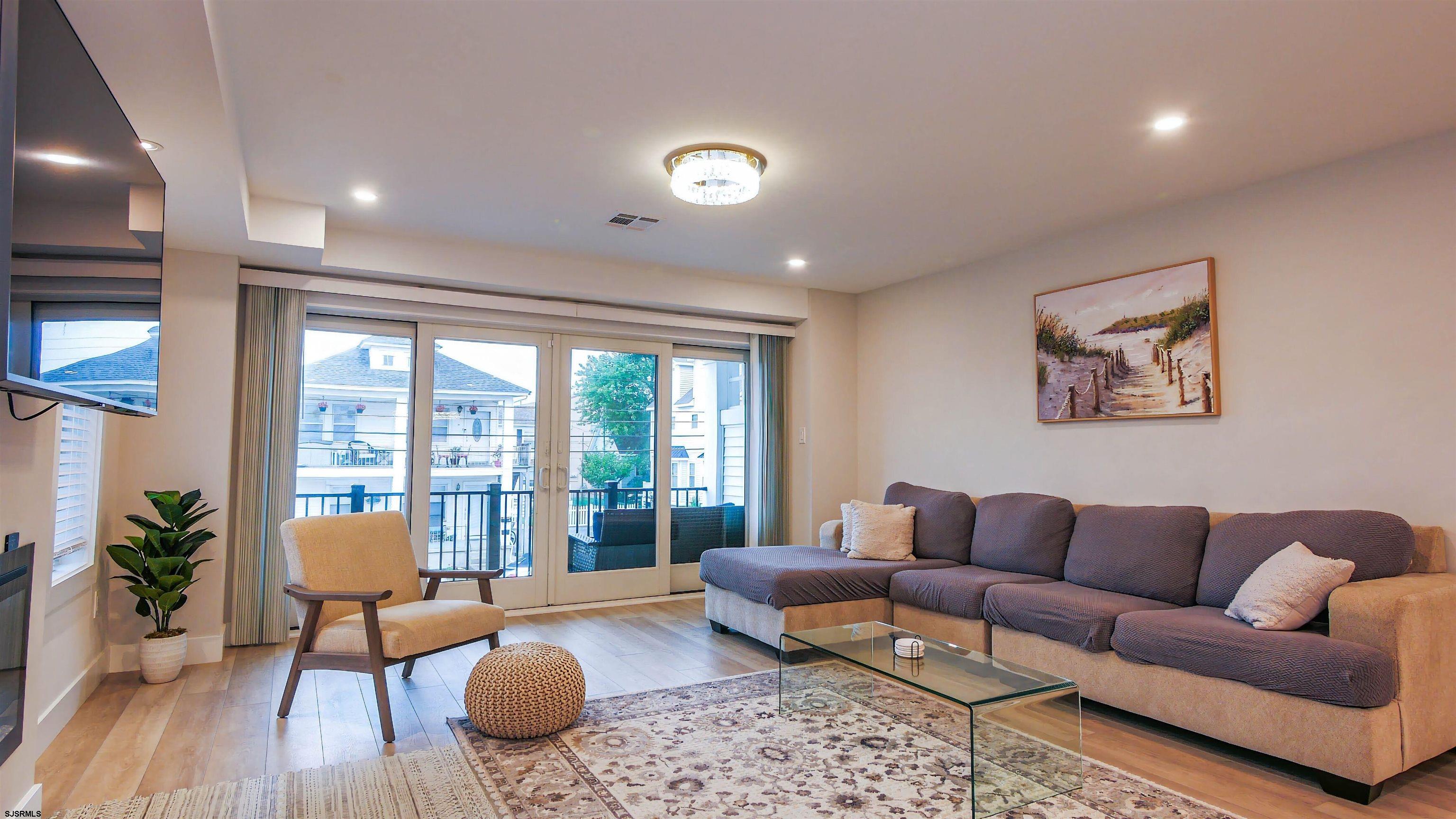 15 North Jefferson Avenue, Unit B Margate City, NJ 08402 - Photo 2 of 13 a living room with furniture and a wooden floor