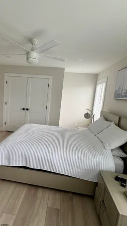 a bedroom with a bed and a night stand
